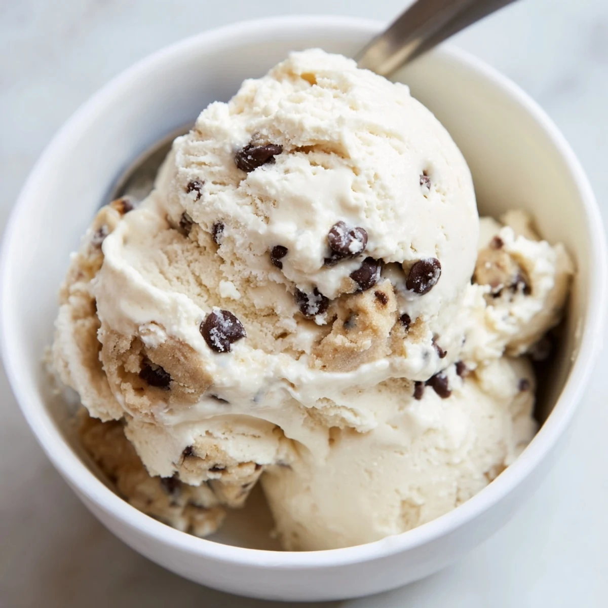 Creamy cottage cheese ice cream adorned with edible cookie dough bites, sheer bliss.