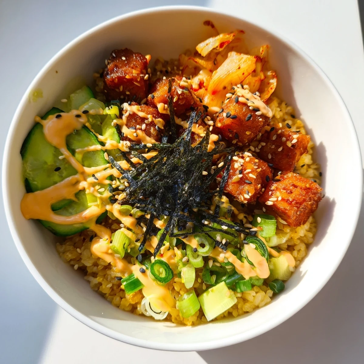 Flavorful crispy salmon rice bowl garnished with crunchy garlic and sesame seeds.  