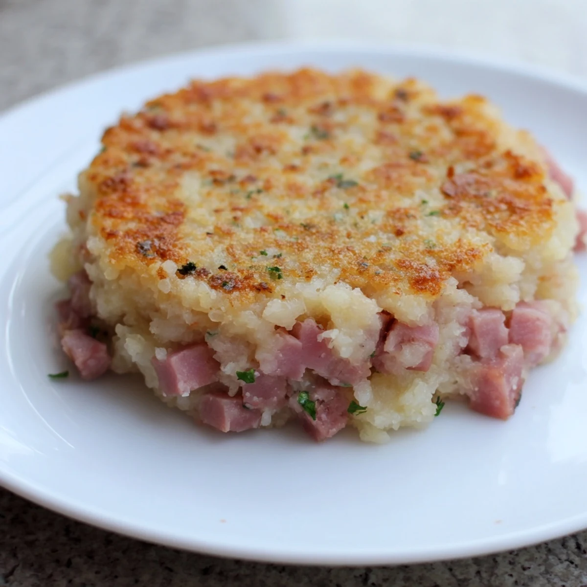 Sizzling in a pan, these Ham & Potato Patties offer a comforting taste of classic American cooking.