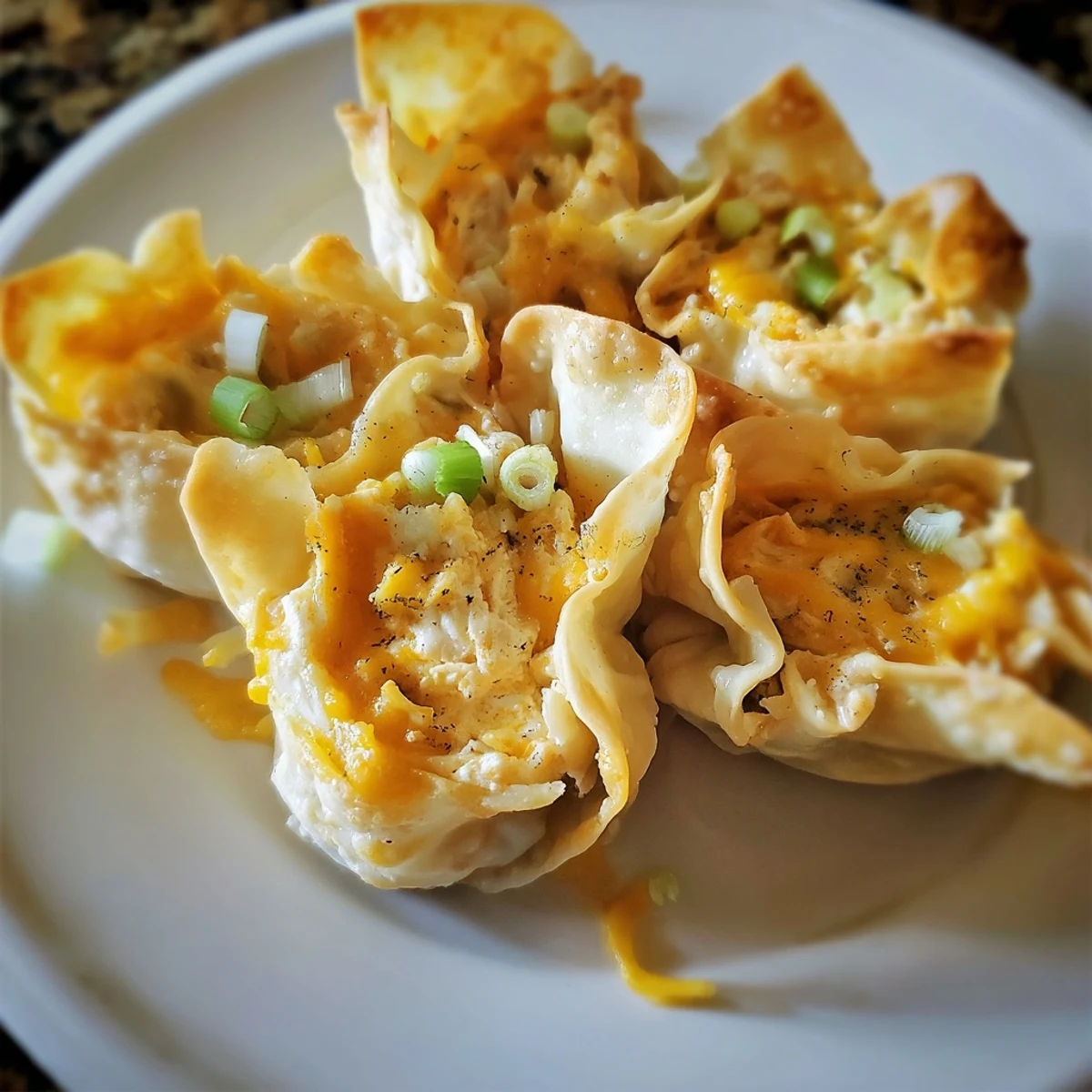 Deliciously flaky Buffalo Chicken Dip Pinwheel Wontons, served hot and ready for dipping in ranch.