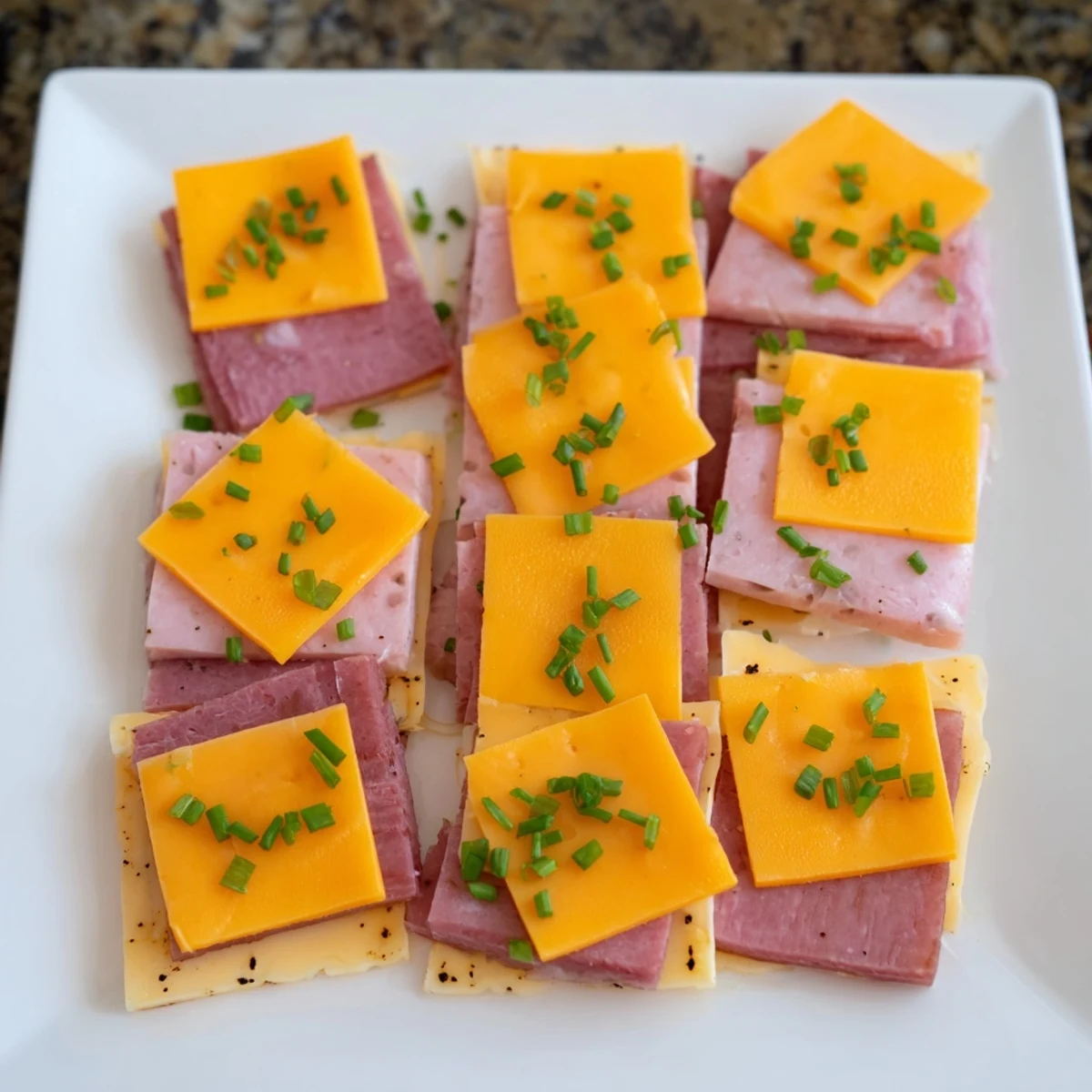 Easy-to-make Checkerboard Picnic Bites, featuring contrasting squares of turkey, Swiss, and savory cheddar cheese.
