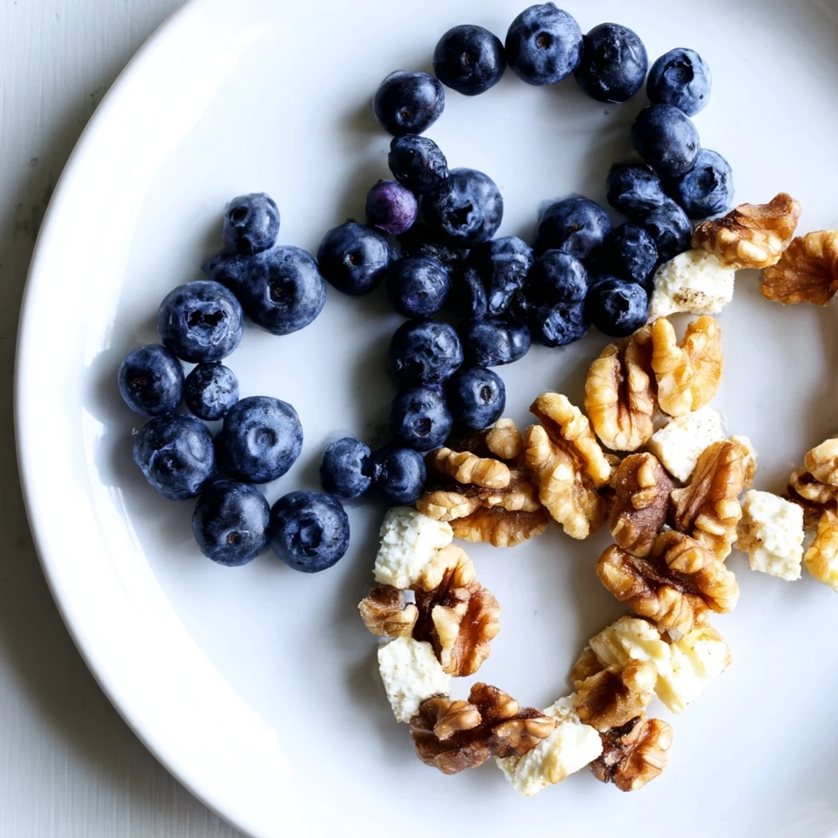 A delicious display of the Olympic Rings interlocking featuring colorful fruits, veggies, and hummus, perfect for sharing.