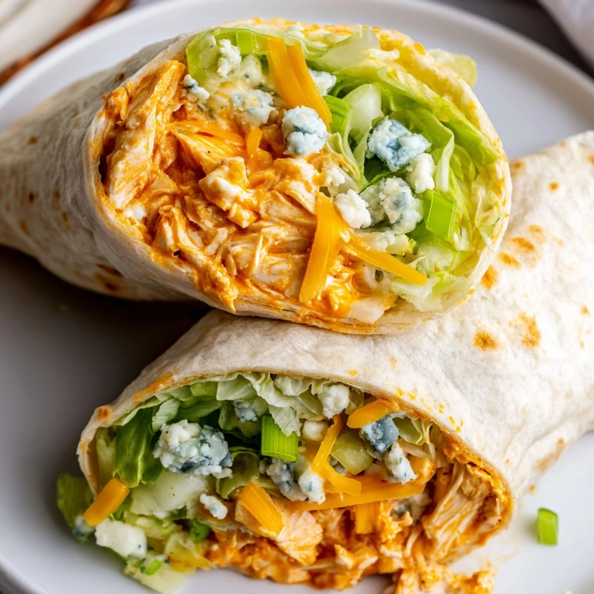Warm and cheesy Buffalo Chicken Dip Wrap, perfectly rolled and ready to eat, served with a side of ranch.