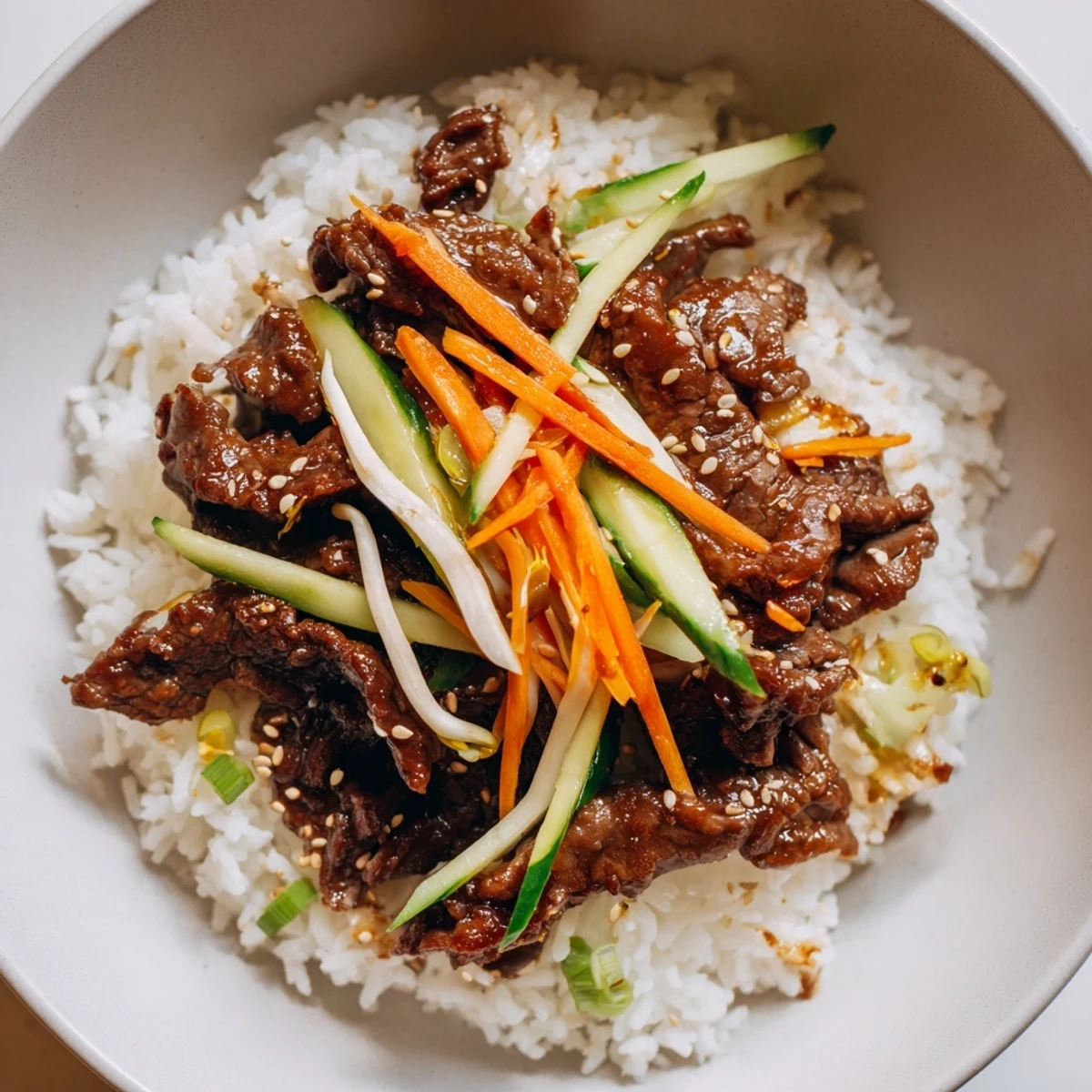 Savory bulgogi beef bowl with glistening marinated beef and colorful, crisp vegetables piled high.