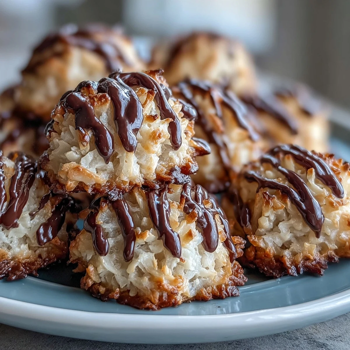 A close-up shows Vegan Coconut Macaroons with Dark Chocolate Drizzle, the glossy dark chocolate setting against fluffy coconut.