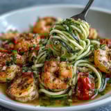 Clinging garlic lemon sauce coats tender zucchini noodles in this Skinny Shrimp Scampi main dish.