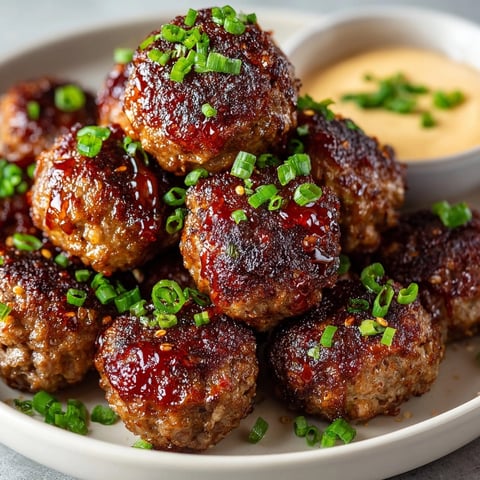 Korean BBQ Meatballs with Spicy Mayo Dip served on a platter, garnished with green onions.