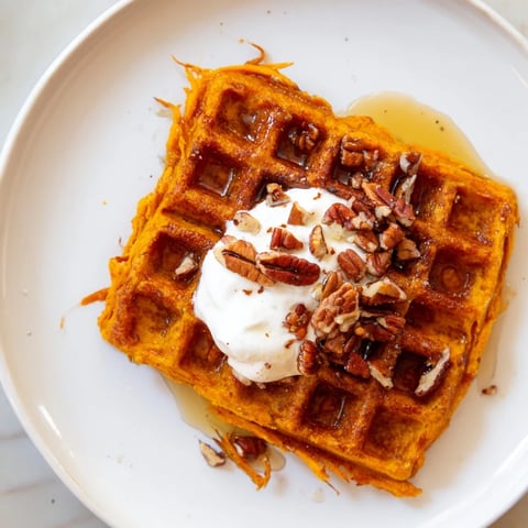 Golden-brown sweet potato waffles freshly cooked ready to be topped with your favorite breakfast delights.
