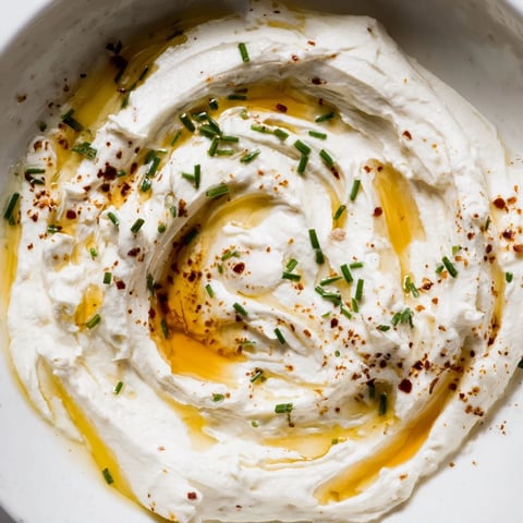 Creamy whipped ricotta dip with a sweet and spicy hot honey swirl, ready to serve.