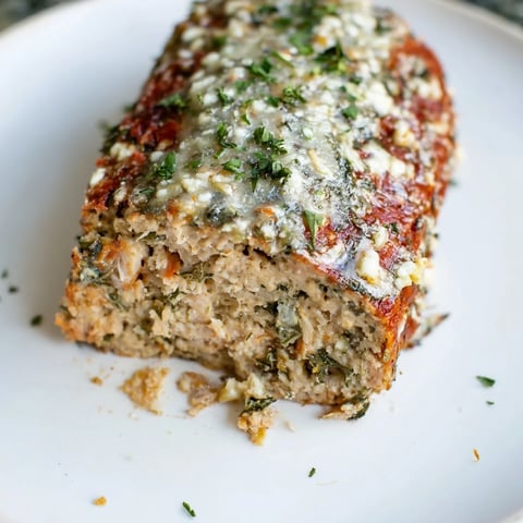 Golden, glazed slices of juicy garlic Parmesan chicken meatloaf, perfect for a family dinner.
