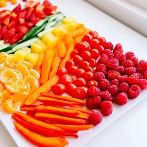 Rainbow Pride Spectrum grazing board displays a delicious spectrum of fresh fruits and vegetables.