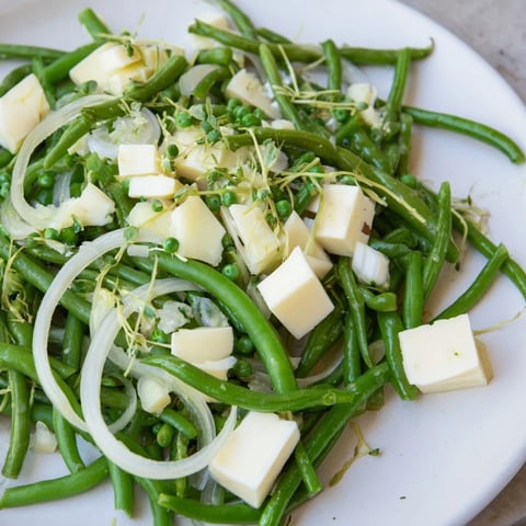 Fresh The English Ivy salad with bright green vegetables, white cheddar, and chives, ready to serve.