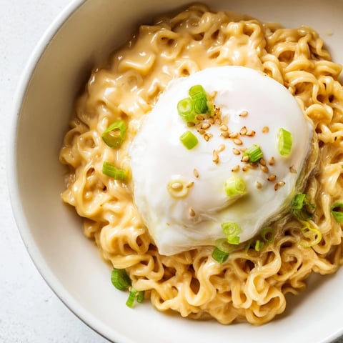 Steaming Instant Cheese Ramen Bowl, with melted cheese and a poached egg, ready to eat.