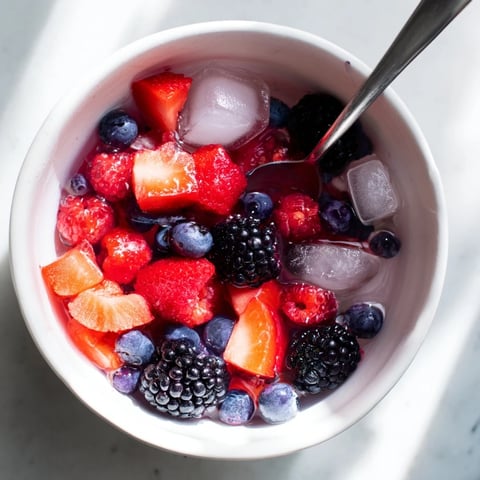 Vibrant Nature's Cereal Bowl, bursting with fresh berries in cool coconut water, is a delightful summer breakfast.