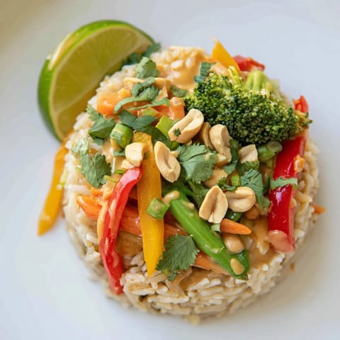 A steaming bowl of colorful Thai Peanut Veggie Stir-Fry Rice—quick, easy, and flavorful vegetarian meal.