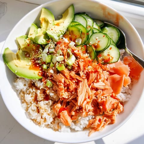 Delicious Leftover Salmon & Rice Bowl drizzled with soy sauce and fresh vegetables.  