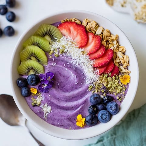Vibrant smoothie bowls featuring creamy yogurt, fresh fruits, and crunchy granola toppings.  