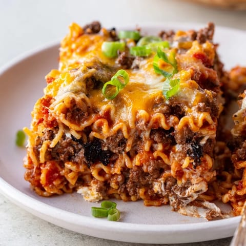 Bold Spicy Ramen Lasagna topped with bubbling mozzarella and rich ground pork flavor.  