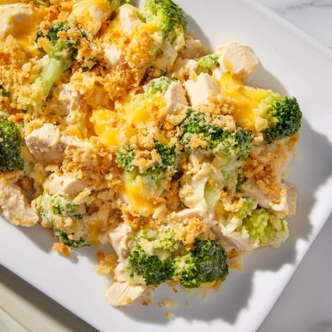 A family-style Chicken & Broccoli Cheddar Bake, featuring tender chicken and broccoli under a bubbly cheddar crust.