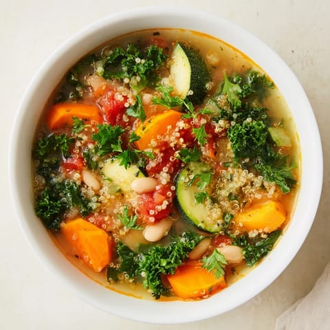 A comforting bowl of hearty Minestrone with Quinoa & Winter Greens, full of fresh vegetables.