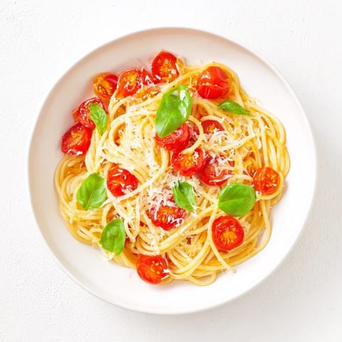 Quick Lazy-Girl Pasta with juicy cherry tomatoes and a hint of red pepper flakes, ready to eat.
