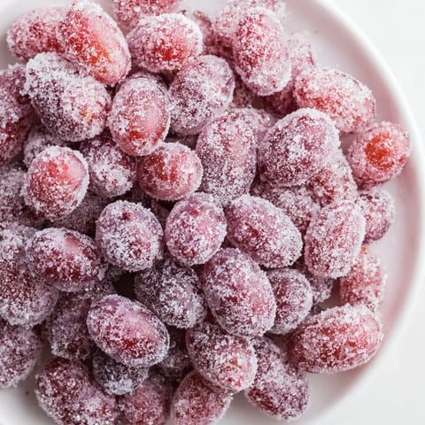 These delightful Quick Frozen Grape Treats are glistening and covered in sparkly sugar, frozen solid and beautiful.