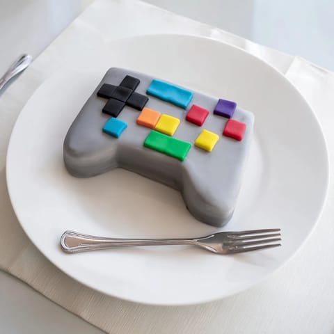 This delicious Pixel Video Game Controller Cake features pixelated details, ideal as a fun dessert for a party.