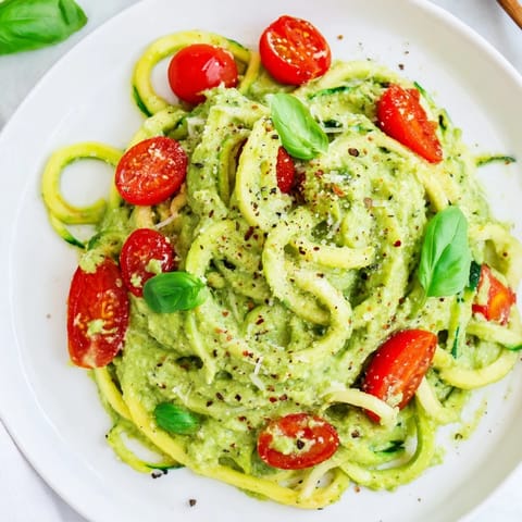 Bright green avocado pesto coats the zoodles, a healthy and delicious Italian-inspired dish.