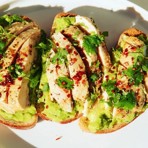Hearty Smashed Avocado Chicken Toast features tender chicken and bright avocado on crispy toast, finished with zesty chili flakes.