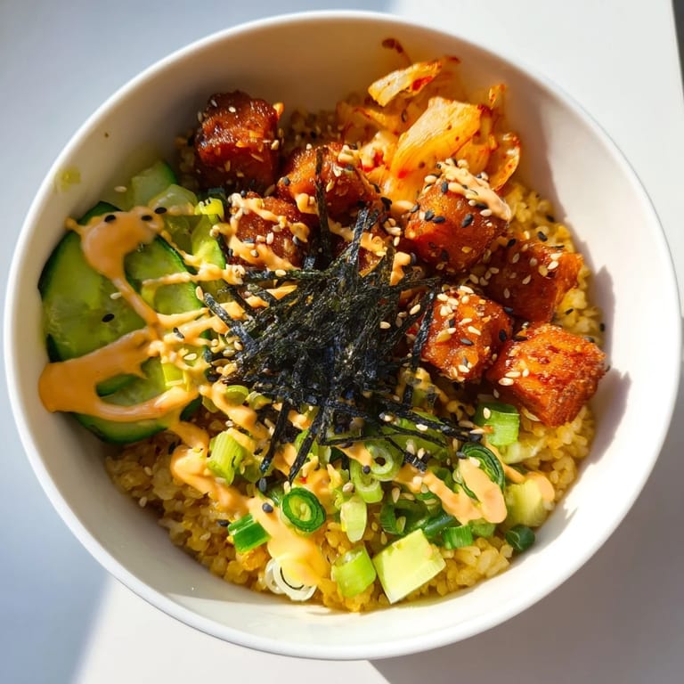 Flavorful crispy salmon rice bowl garnished with crunchy garlic and sesame seeds.  