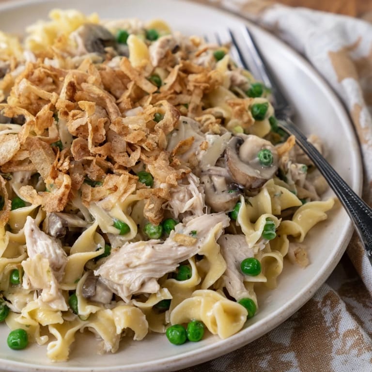 A close-up of a creamy Tuna Noodle Casserole with a bubbling, cheesy filling.