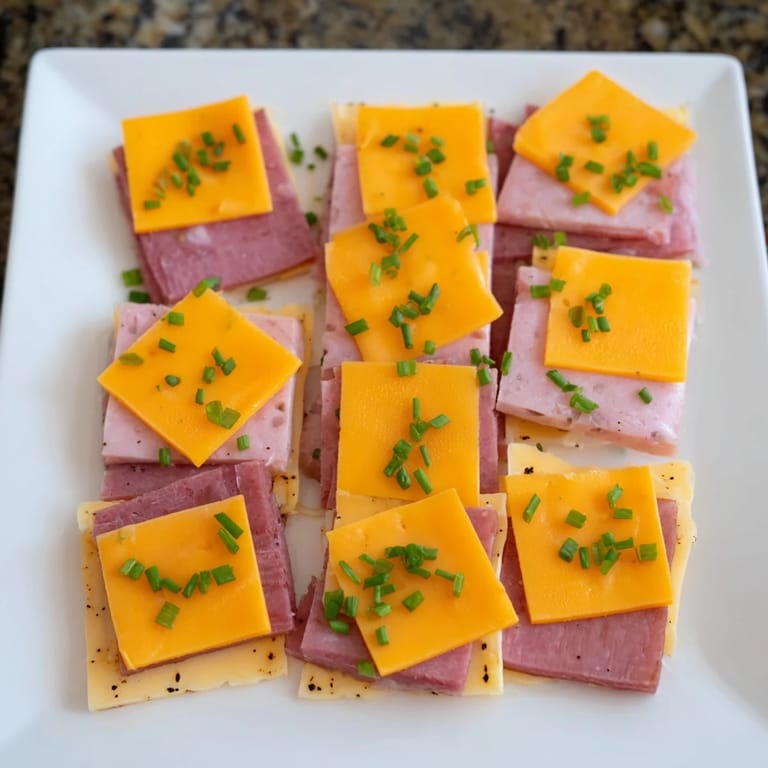 Easy-to-make Checkerboard Picnic Bites, featuring contrasting squares of turkey, Swiss, and savory cheddar cheese.