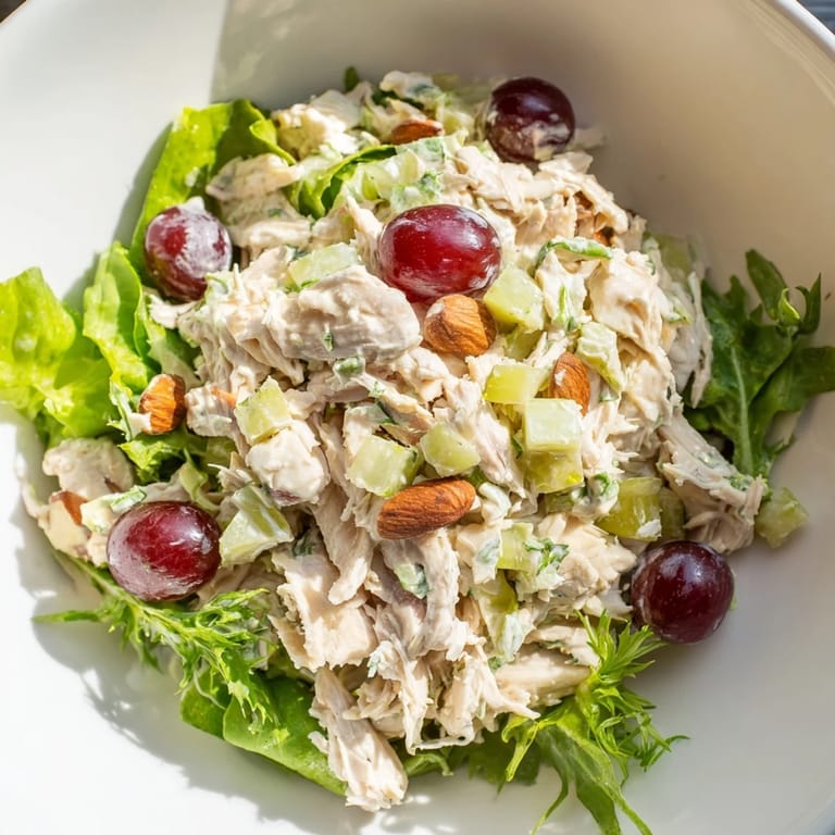 A refreshing bowl of crispy chicken salad featuring tender chicken and juicy grapes, perfect for lunch.