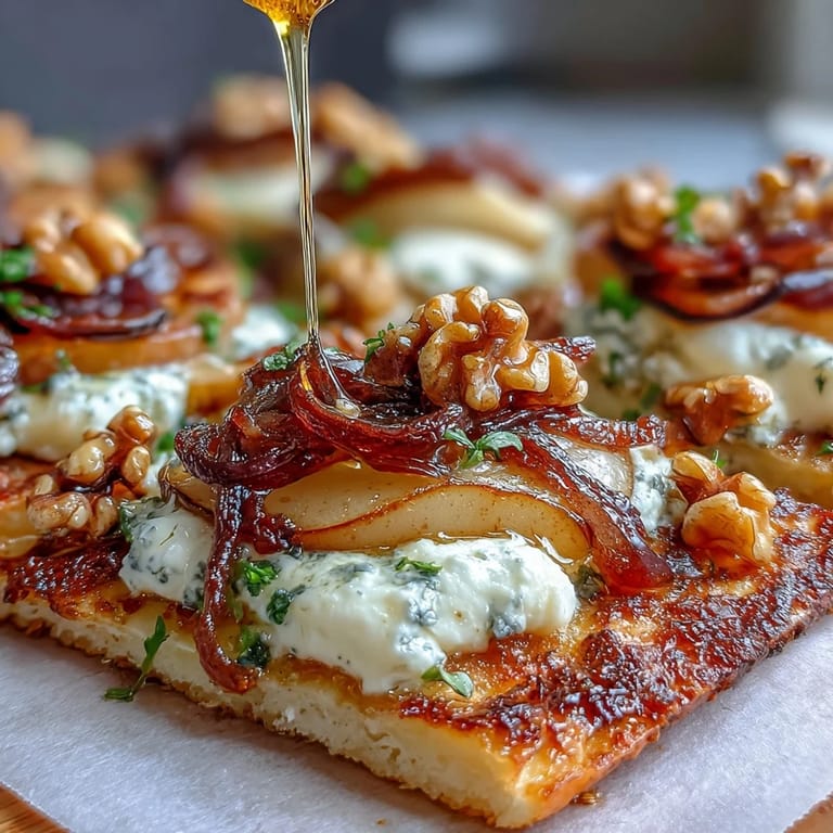 Warm flatbread topped with tangy goat cheese, juicy pears, savory caramelized onions, walnuts, and a sweet-spicy hot honey drizzle.